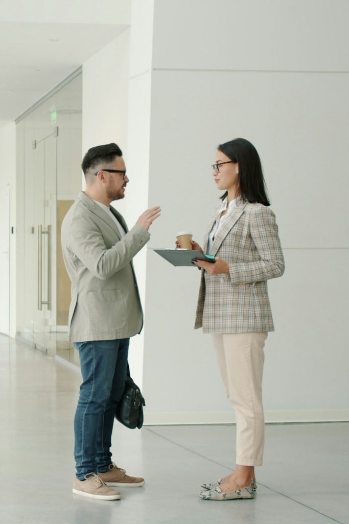 Two colleagues talking in a bright office